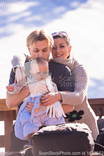 Image of young happy family with little child enjoying winter day