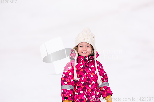 Image of little girl having fun at snowy winter day