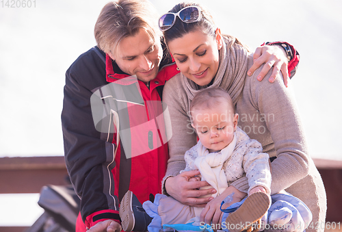 Image of young happy family with little child enjoying winter day