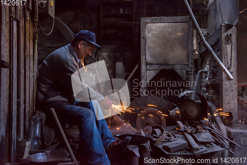 Image of the blacksmith polishing metal products