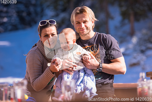 Image of young happy family with little child enjoying winter day