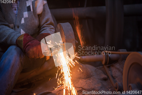 Image of the blacksmith polishing metal products