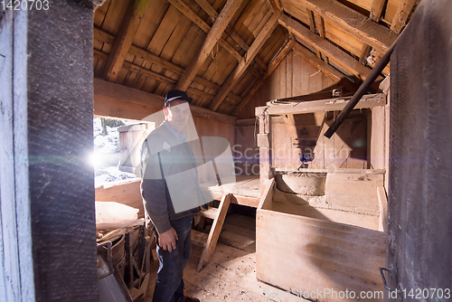Image of portrait of a miller in retro wooden watermill