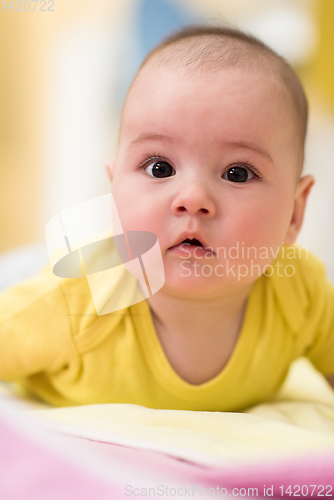 Image of newborn baby boy playing on the floor