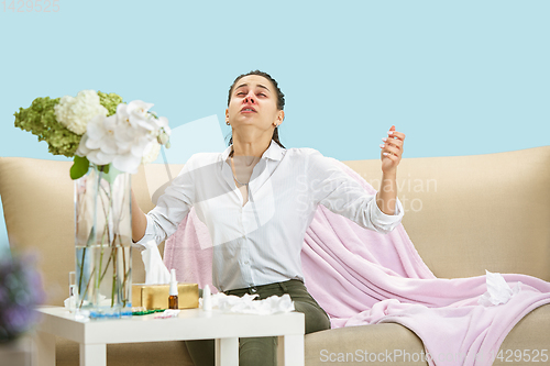 Image of Young woman suffering from hausehold dust or seasonal allergy.