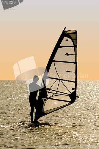 Image of Silhouette of a windsurfer on waves of a gulf 