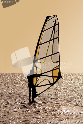 Image of Silhouette of a windsurfer on waves 