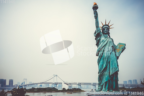 Image of Statue of liberty and tokyo cityscape, Japan