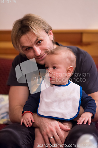 Image of Portrait of young father and his cute baby son