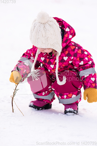 Image of little girl having fun at snowy winter day