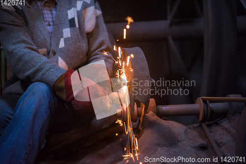 Image of the blacksmith polishing metal products