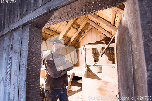 Image of portrait of a miller in retro wooden watermill