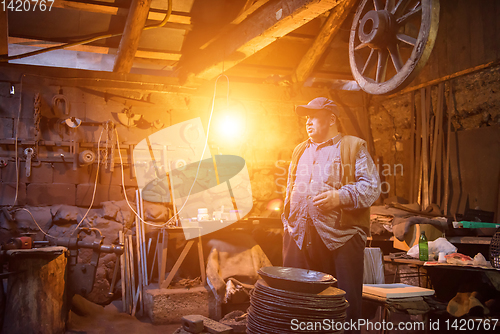 Image of portrait of confident senior blacksmith