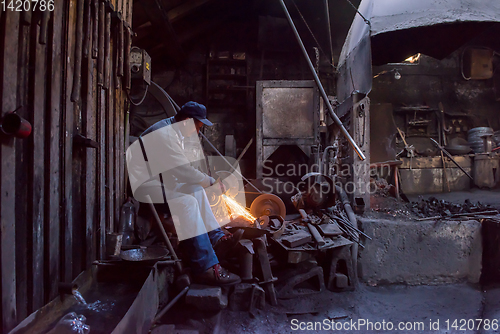 Image of the blacksmith polishing metal products