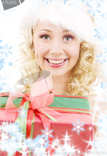 Image of cheerful santa helper girl with gift box