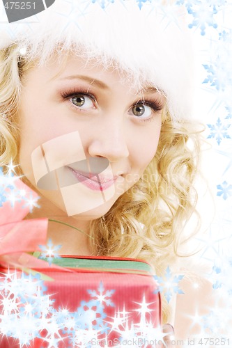 Image of cheerful santa helper girl with gift box