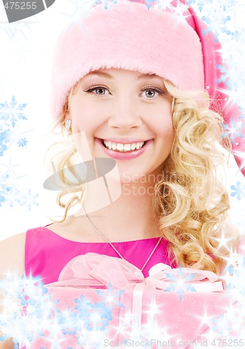 Image of cheerful santa helper girl with gift box