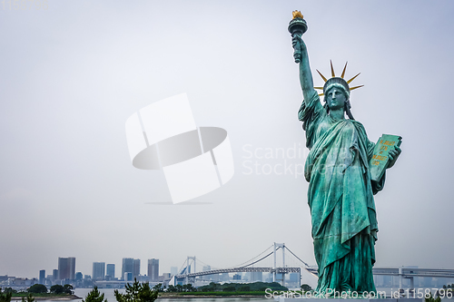 Image of Statue of liberty and tokyo cityscape, Japan