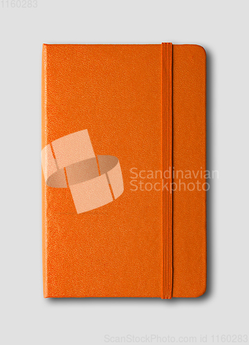 Image of Orange closed notebook isolated on grey