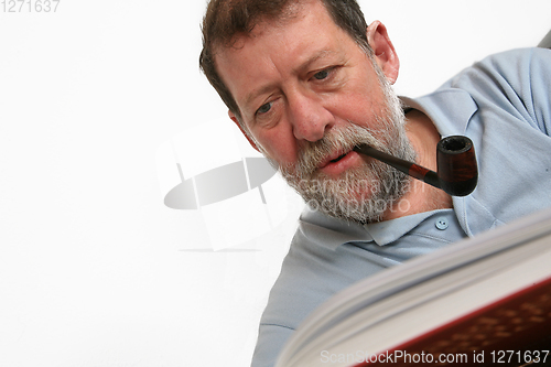 Image of Mature scandinavian man reading a book 