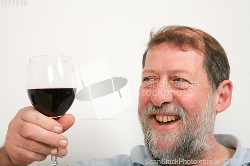Image of Mature scandinavian man drinking red vine