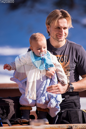 Image of young happy family with little child enjoying winter day