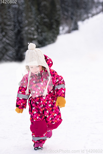 Image of little girl having fun at snowy winter day