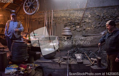 Image of portrait of two generations traditional blacksmith