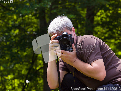 Image of male photographer photographing nature
