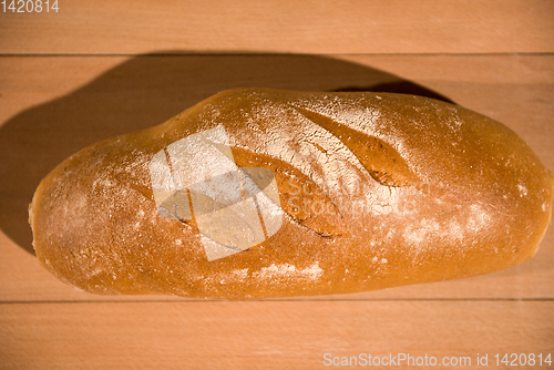 Image of fresh bread on wooden table