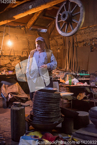 Image of portrait of confident senior blacksmith