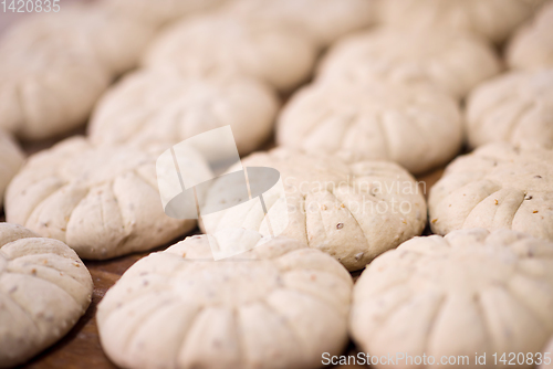 Image of balls of dough bread getting ready to be baked