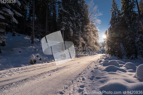 Image of Snowy country road during  sunset or sunrise