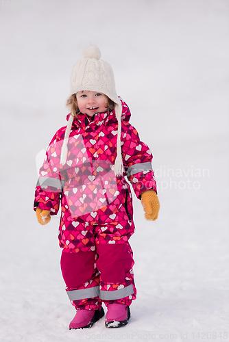 Image of little girl having fun at snowy winter day