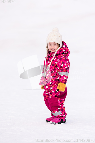 Image of little girl having fun at snowy winter day