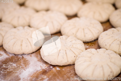 Image of balls of dough bread getting ready to be baked