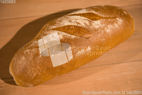 Image of fresh bread on wooden table