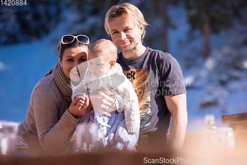 Image of young happy family with little child enjoying winter day