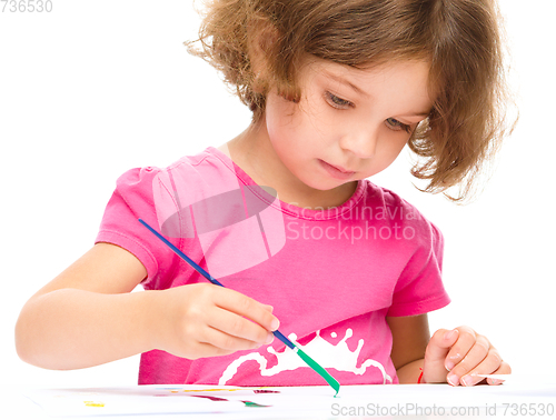 Image of Little girl is painting with gouache