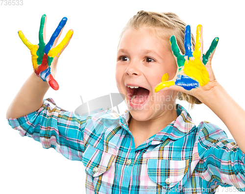 Image of Portrait of a cute girl playing with paints