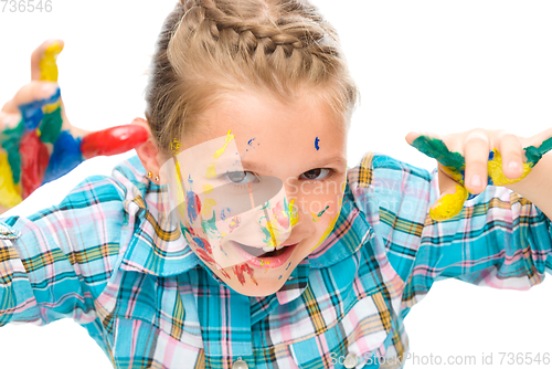 Image of Portrait of a cute girl playing with paints
