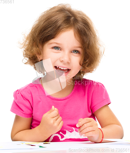 Image of Little girl is painting with gouache