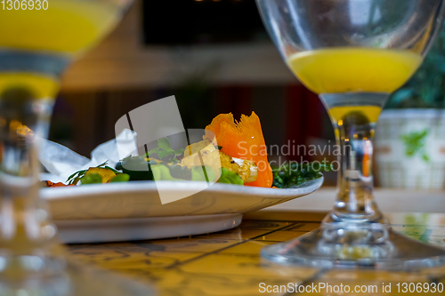 Image of Closeup of salmon salad and orange juice. 