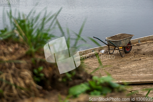 Image of Wheelbarrow for construction in site building area.