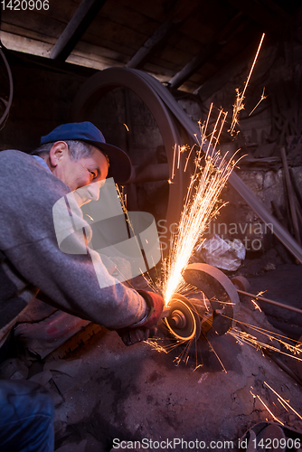 Image of the blacksmith polishing metal products