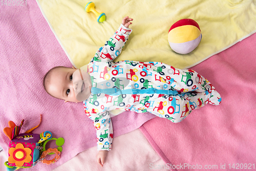 Image of top view of newborn baby boy lying on colorful blankets