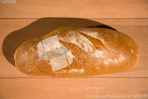 Image of fresh bread on wooden table