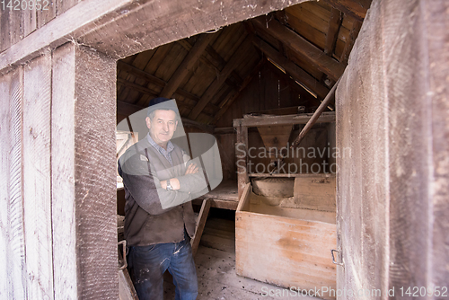 Image of portrait of a miller in retro wooden watermill