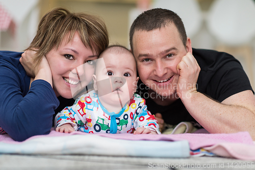 Image of Portrait of young happy couple with their adorable baby boy