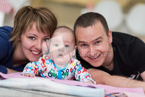 Image of Portrait of young happy couple with their adorable baby boy